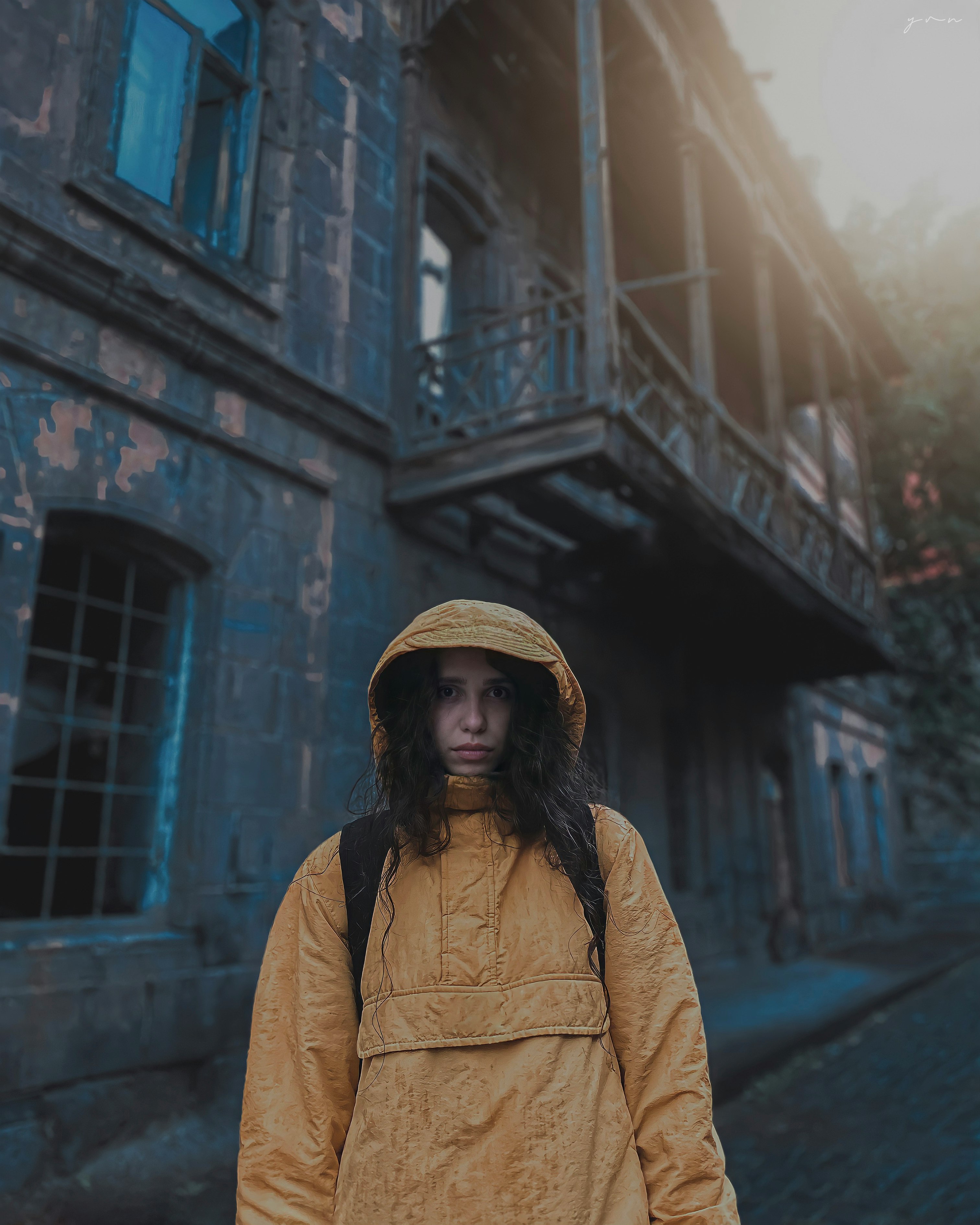 woman in brown coat and brown hat standing near brown concrete building during daytime